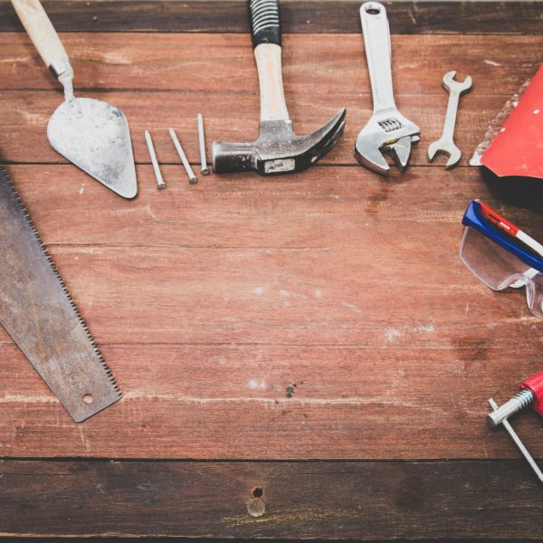 pexels-photo-1029243-1029243 Flat lay of various workshop tools on a rustic wooden table, showcasing DIY essentials.